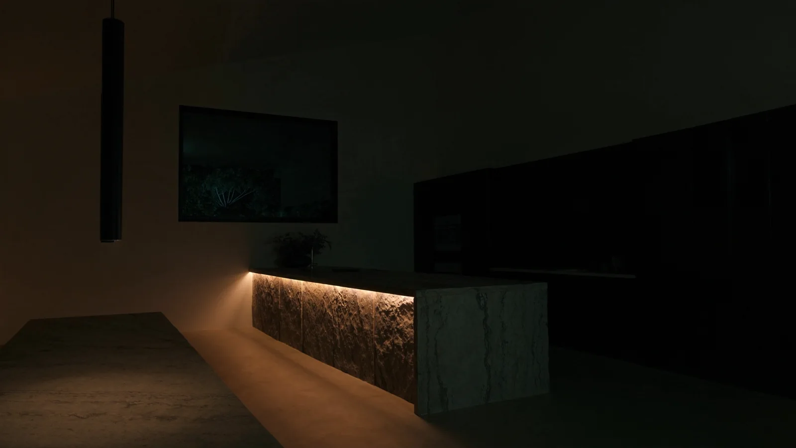 Under-cabinet strip lighting and pendants lit over a stone kitchen bench after dark